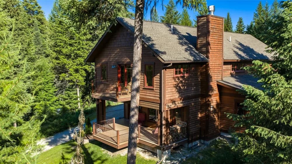 Wood-clad home among evergreen trees
